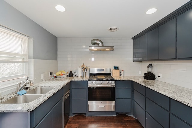 3300 Cambridge St, Odessa, TX 79761 - kitchen with gas stove, dark wood-style floors, backsplash, under cabinet range hood, and light stone counters