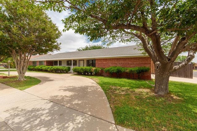 3300 Cambridge St, Odessa, TX 79761 - single story home with a front lawn, brick siding, and curved driveway
