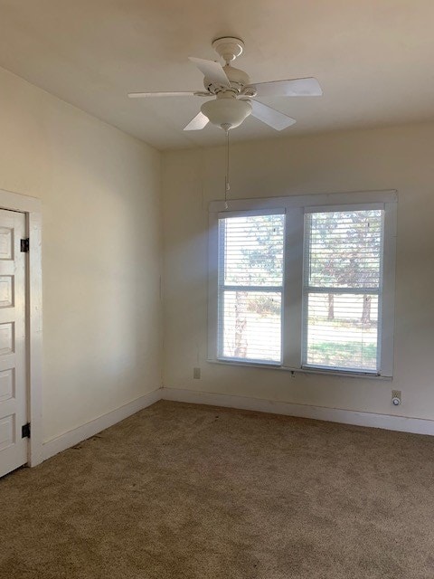 spare room with carpet and ceiling fan