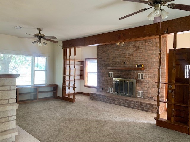 unfurnished living room featuring carpet flooring, a fireplace, and ceiling fan