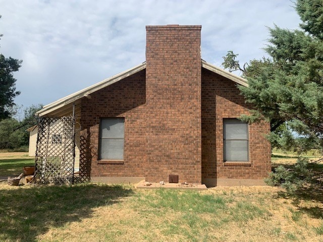 view of side of home featuring a yard