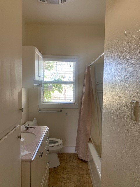 full bathroom featuring shower / bath combination with curtain, vanity, and toilet