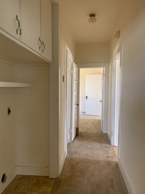 hallway with light colored carpet