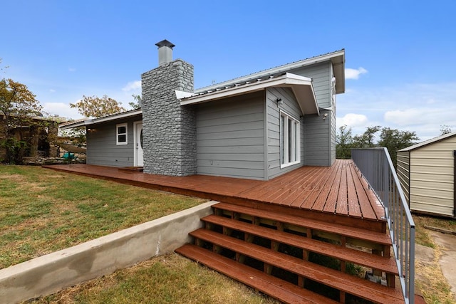 rear view of property with a lawn and a wooden deck