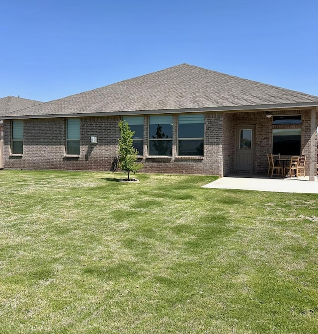 7103 Mcpherson Ln, Midland, TX 79706 - back of house with a patio, brick siding, and roof with shingles
