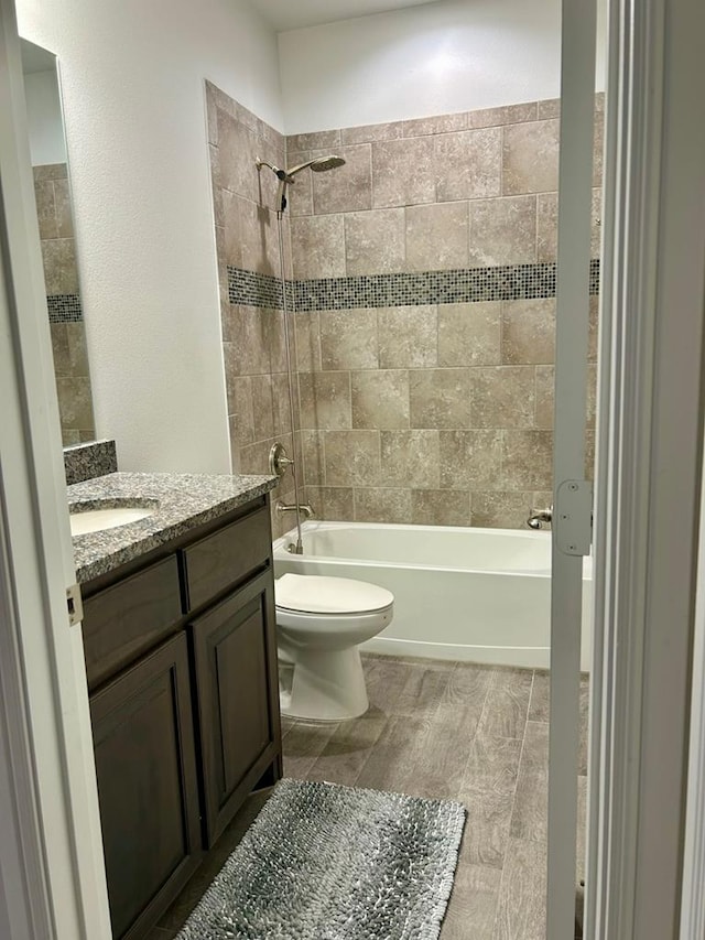 7103 Mcpherson Ln, Midland, TX 79706 - full bathroom featuring vanity,  shower combination, and wood finished floors