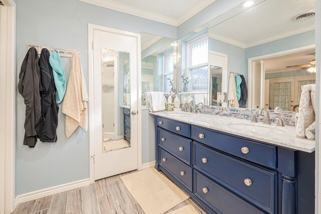 bathroom with vanity, ceiling fan, and crown molding