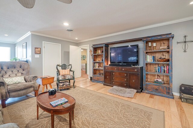 living room featuring hardwood / wood-style flooring and ornamental molding