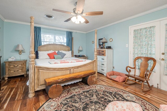 bedroom featuring ceiling fan, ornamental molding, dark hardwood / wood-style flooring, and a textured ceiling