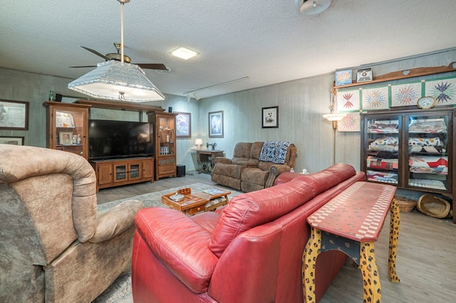 living room with light hardwood / wood-style floors and a textured ceiling