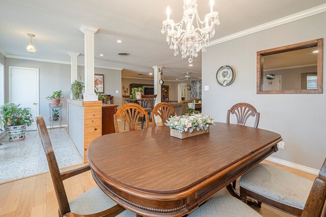 dining room with decorative columns, light hardwood / wood-style flooring, ceiling fan, and ornamental molding