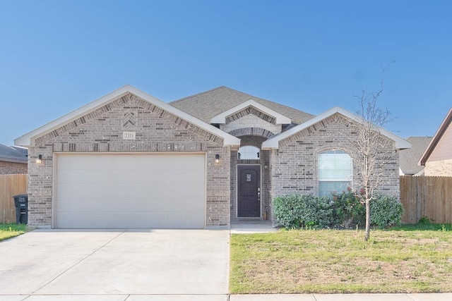 7318 Cross B Rd, Odessa, TX 79765 - french country style house with brick siding, concrete driveway, and a garage