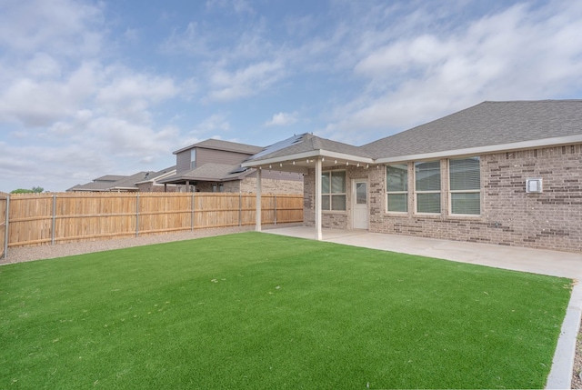 7318 Cross B Rd, Odessa, TX 79765 - back of house with a fenced backyard, brick siding, a patio area, and a shingled roof