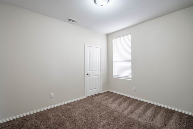 7318 Cross B Rd, Odessa, TX 79765 - unfurnished room with dark colored carpet and baseboards