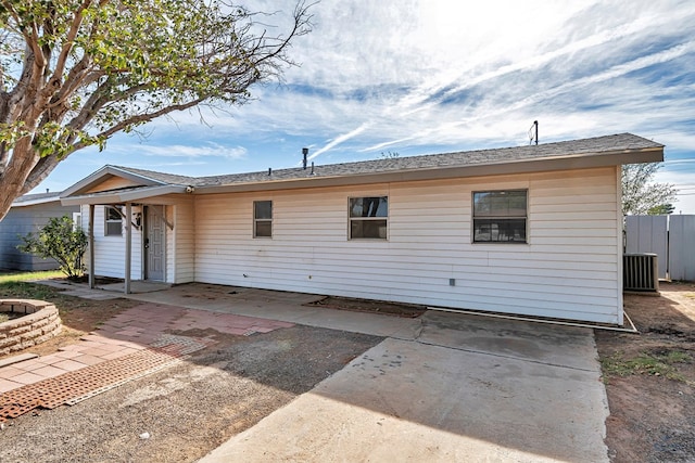 rear view of house featuring central air condition unit and a patio