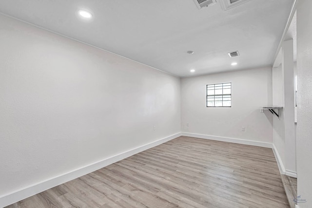 spare room featuring light hardwood / wood-style flooring