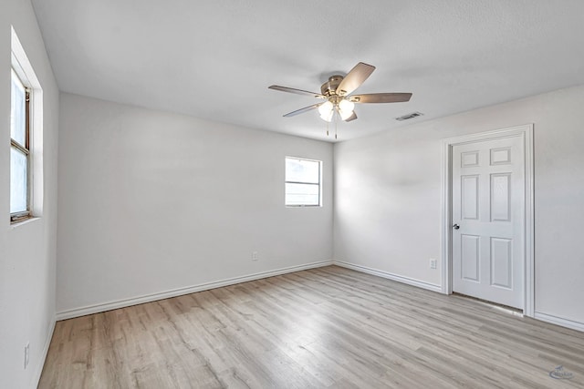 unfurnished room featuring ceiling fan, a textured ceiling, and light hardwood / wood-style flooring