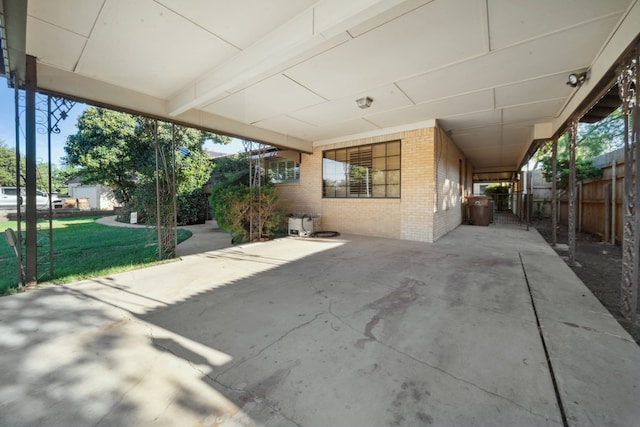 view of patio / terrace featuring a gate, a carport, and fence