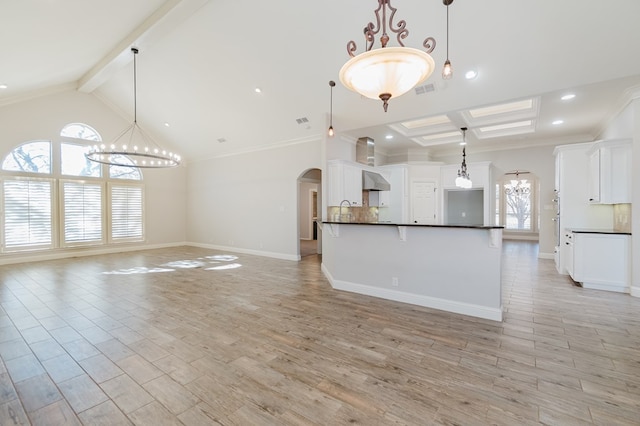 kitchen with beam ceiling, decorative light fixtures, and a chandelier