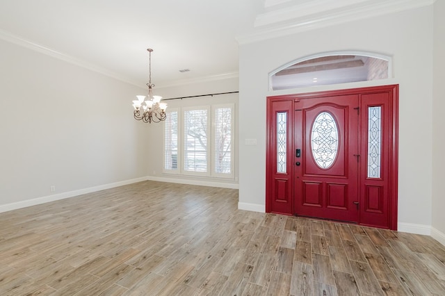 entryway featuring ornamental molding, a chandelier, and light wood-type flooring