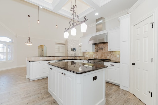 kitchen featuring white cabinetry, pendant lighting, kitchen peninsula, and a kitchen island