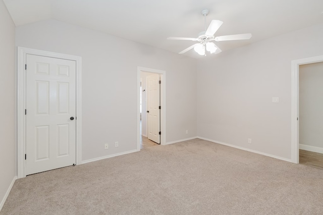 unfurnished bedroom with lofted ceiling, light colored carpet, and ceiling fan