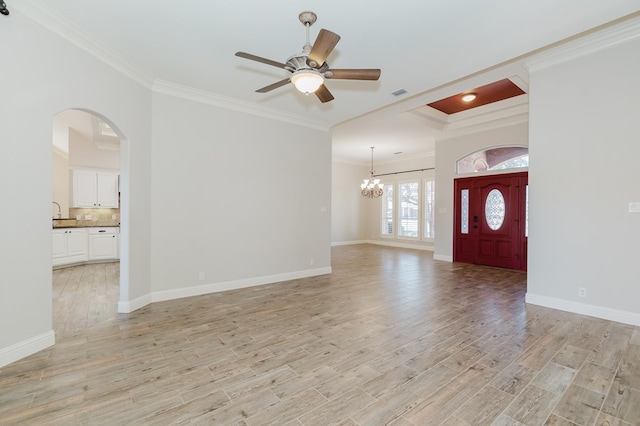 foyer entrance featuring crown molding, ceiling fan with notable chandelier, and light hardwood / wood-style flooring