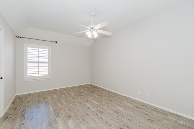 empty room featuring vaulted ceiling, ceiling fan, and light hardwood / wood-style floors