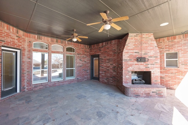 view of patio featuring an outdoor brick fireplace and ceiling fan