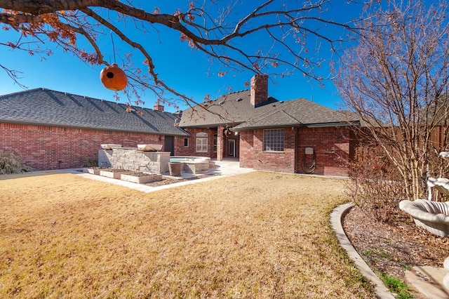 rear view of house featuring a lawn and a patio area