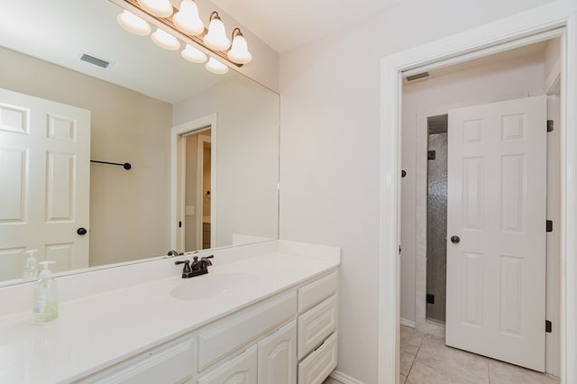 bathroom with tile patterned floors, vanity, and a shower