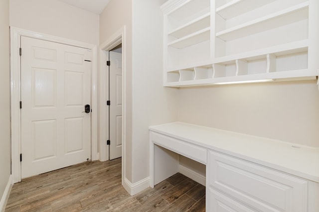 hallway with hardwood / wood-style flooring