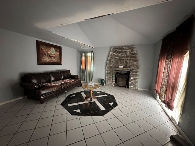 tiled living room with a brick fireplace, a wealth of natural light, and vaulted ceiling