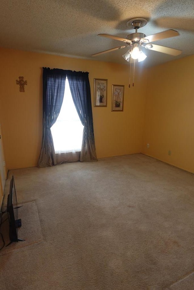 2511 Fontana St, Odessa, TX 79763 - spare room with carpet flooring, a ceiling fan, and a textured ceiling