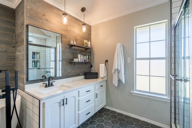 bathroom featuring crown molding, wood walls, vanity, tiled shower, and baseboards