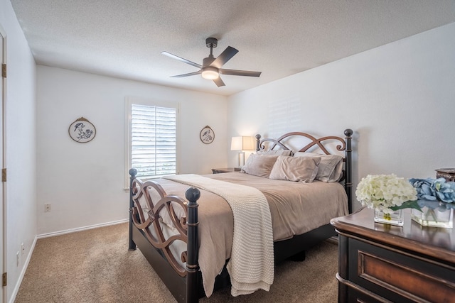 bedroom featuring baseboards, carpet, a ceiling fan, and a textured ceiling