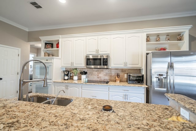 kitchen featuring light stone counters, a toaster, open shelves, appliances with stainless steel finishes, and white cabinetry