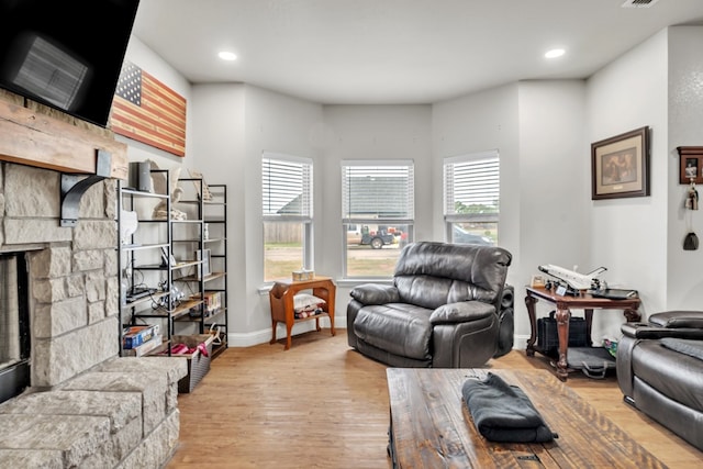 602 Frank Davis Ave, Coahoma, TX 79720 - living room featuring plenty of natural light, wood finished floors, a stone fireplace, baseboards, and recessed lighting
