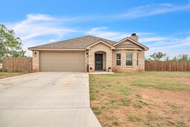 602 Frank Davis Ave, Coahoma, TX 79720 - view of front of property featuring stone siding, concrete driveway, a garage, a chimney, and a shingled roof
