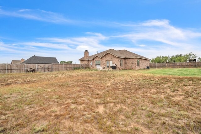 602 Frank Davis Ave, Coahoma, TX 79720 - rear view of property with a chimney and brick siding