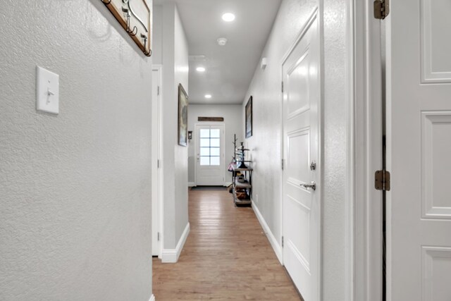 602 Frank Davis Ave, Coahoma, TX 79720 - hallway with light wood-type flooring, baseboards, a textured wall, and recessed lighting