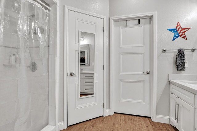 602 Frank Davis Ave, Coahoma, TX 79720 - full bathroom with a shower stall, vanity, and wood finished floors