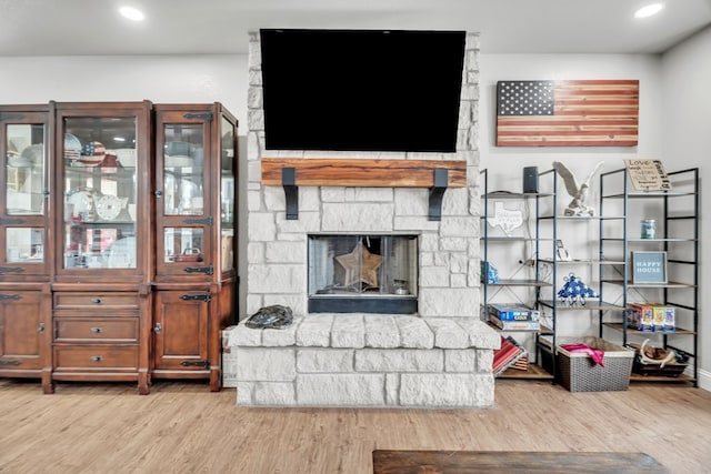 602 Frank Davis Ave, Coahoma, TX 79720 - living area featuring wood finished floors, a stone fireplace, and recessed lighting