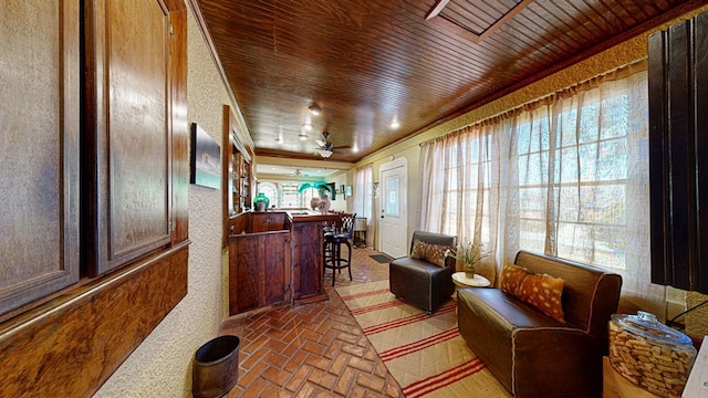 interior space with ceiling fan and wooden ceiling