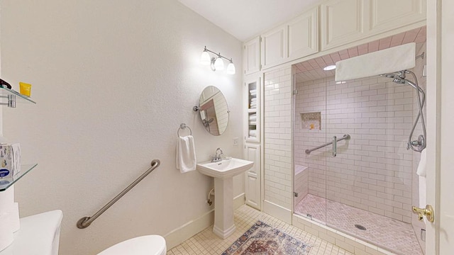 bathroom with toilet, tile patterned floors, and an enclosed shower