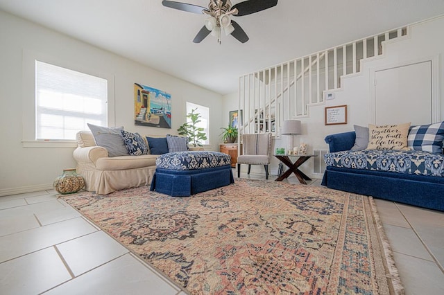 tiled living room with ceiling fan