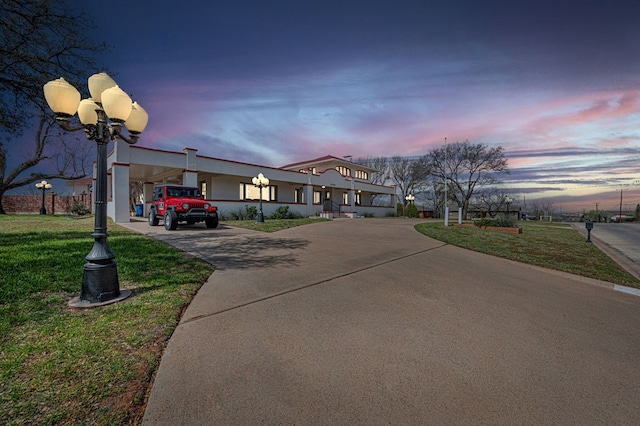 view of front of property with a yard and a carport