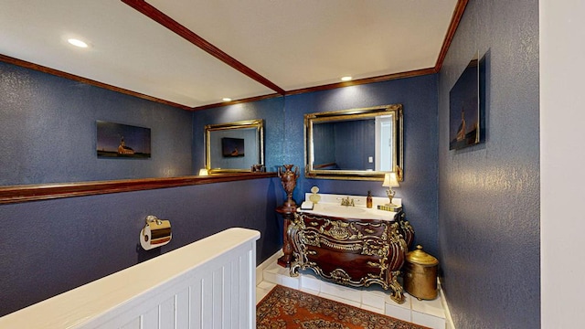 bathroom with tile patterned flooring, vanity, and crown molding