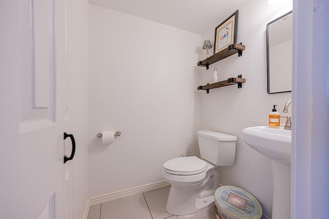 bathroom featuring tile patterned floors and toilet