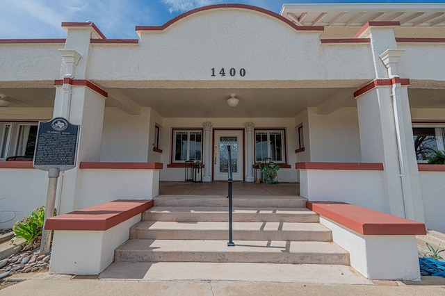 entrance to property featuring covered porch